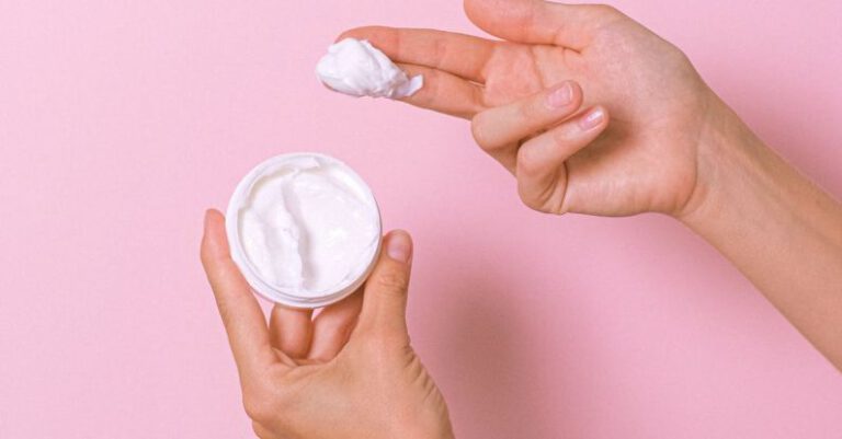 Therapy - Unrecognizable person with can of moisturizing cosmetic cream for daily routine in hands on pink background in studio during procedure