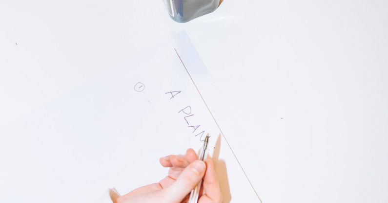 Plan - Person Writing on White Paper