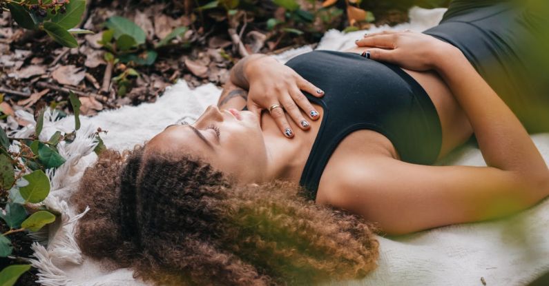 Grounding Techniques - Woman Wearing Black Tank Top Lying on White Towel