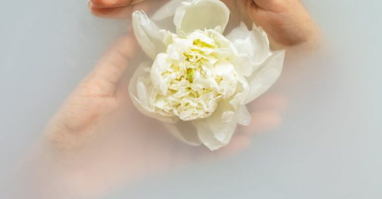 Light Therapy - Anonymous woman with gentle white flower in water