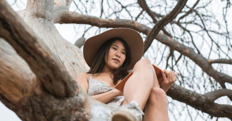 Books - A Woman Sitting on a Tree Branch